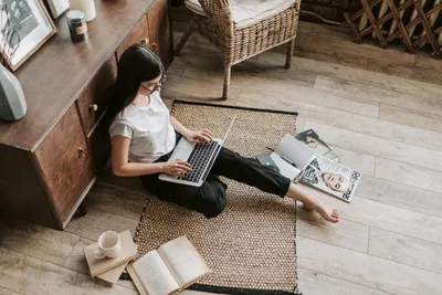 Confident young businesswoman with laptop and notebook sitting on floor  modern apartment · Free Stock Photo
