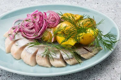 селедка с картошкой и луком на тарелке Stock Photo | Adobe Stock