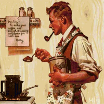 A man holding a plate of cookies in a kitchen Photo